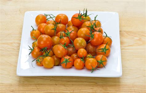 Orange Cherry Tomatoes Displayed On White Plate Stock Photo Image Of