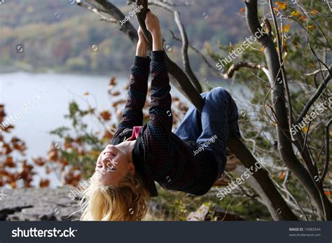 Girl Hanging Upside Down From A Tree Stock Photo Shutterstock