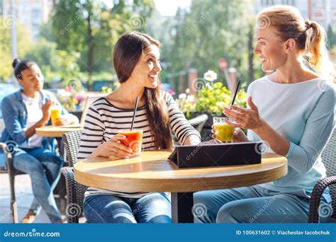 Two Friends Talking And Drinking Smoothie In Cafe Stock Photo Image