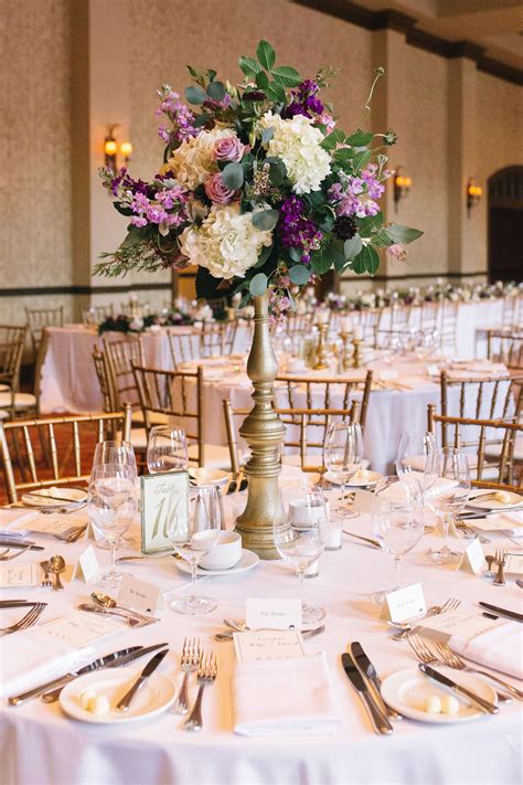 wedding reception centerpiece of white hydrangea lavender roses purple stock lavender