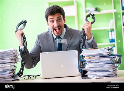 Employee Chained To His Desk Due To Workload Stock Photo Alamy