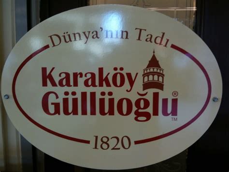 A White Sign With Red Lettering That Reads Duiyan Un Taddi Karakoy