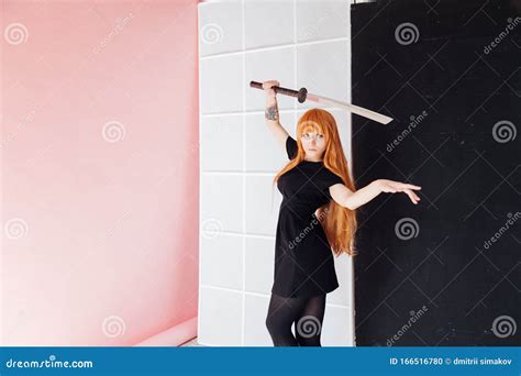 Woman Anime With Red Hair With Japanese Samurai Sword Stock Photo