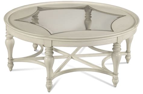 This coffee table's top can be lifted off and the legs can be folded flat to allow for easy storage. Sanibel White Round Cocktail Table from Bassett Mirror ...