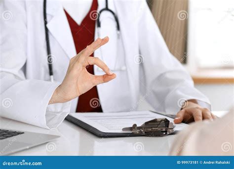 Close Up Of A Doctor Hand Showing Ok Sign While Phusician And His Patient Discussing Medical