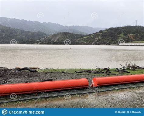 Orange Floating Debris Boom Barrier On Ground Of Reservoir During The