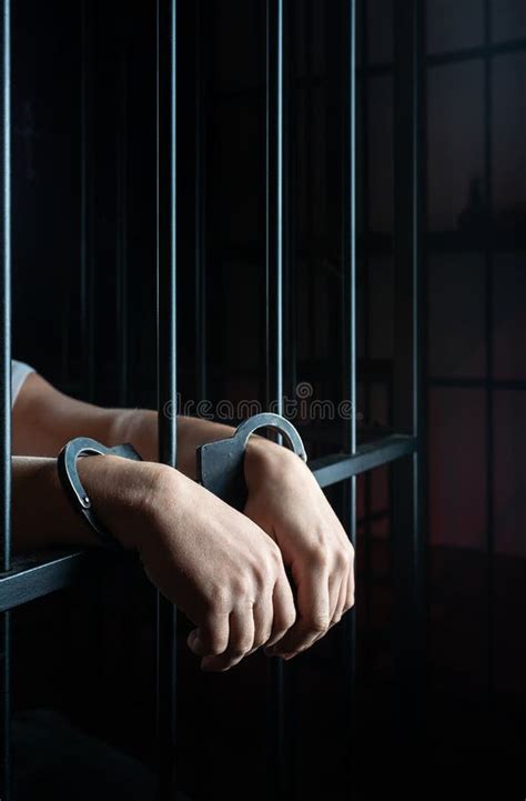 Hands In Handcuffs Behind Bars Stock Photo Image Of Handcuffs Person