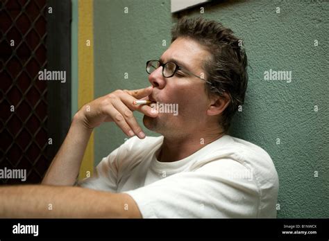 Man Leaning Against Wall Smoking Cigarette Hi Res Stock Photography And