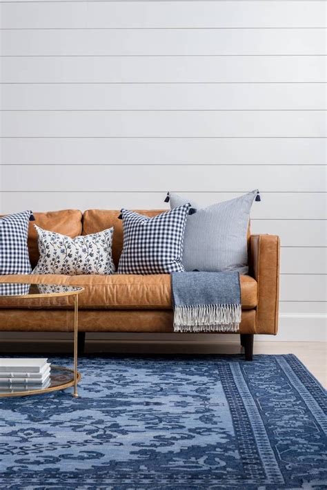 We love the brown leather and the brass rivets. blue rug + leather couch | Blue rugs living room, Leather ...