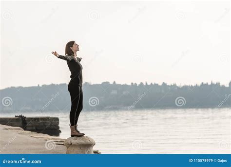 Woman Standing On A Cement Bollard On A Quay Stock Image Image Of Female Freedom 115578979