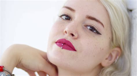 Beautiful Young Blond Woman With A Pierced Lip Wearing Crimson Lipstick