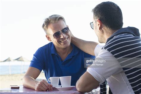 Two Gay Men Relaxing At Beach Bar Photo Getty Images