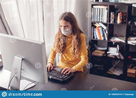 Teen Gaming At Home With Computer Wearing Protective Mask Stock Photo