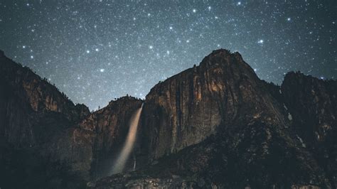 Download Wallpaper 1366x768 Waterfall Night Mountains Cliff Tablet