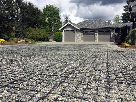 The Driveway Is Made Out Of Rocks And Gravel