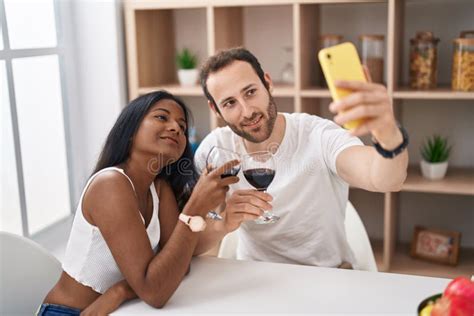Man And Woman Interracial Couple Drinking Wine Make Selfie By Smartphone At Home Stock Image