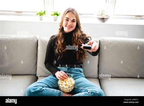 A Teenage Girl Relaxing At Home Watching Television Stock Photo Alamy