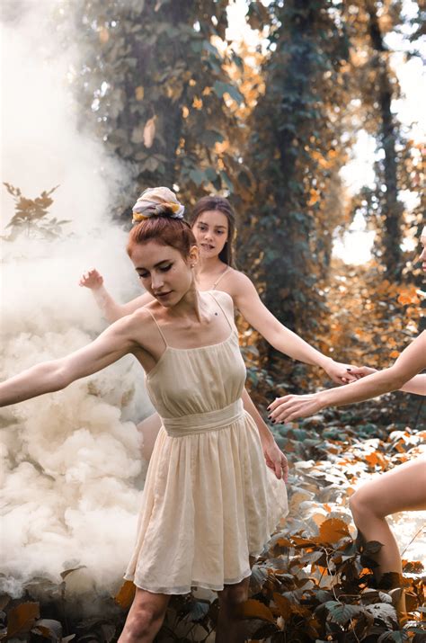 Three Women Dancing Near Tall Trees With White Fogs Photo Free Human Image On Unsplash