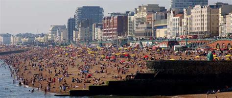 Environmentalists Go Naked To Strip Brighton Beach Of Rubbish Title