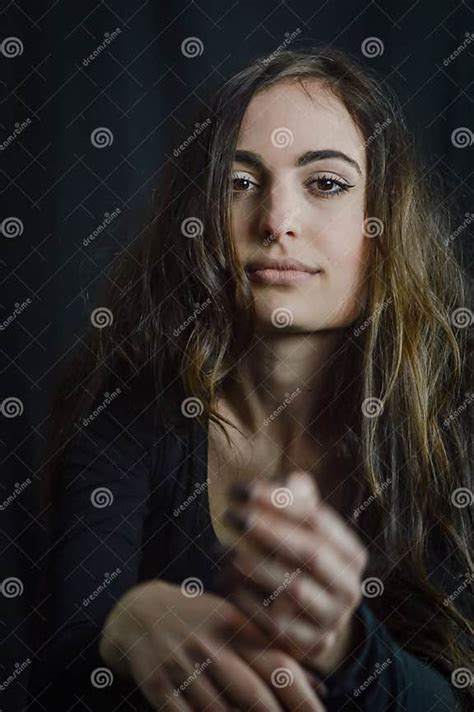 portrait of a beautiful italian girl with long hair gesticulating with a seductive look stock