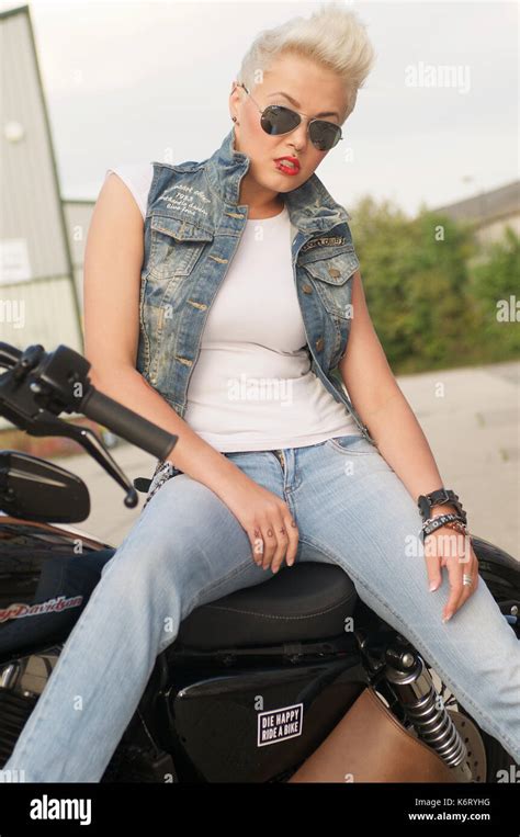 Beautiful Short Haired Blonde Girl With A Harley Davidson Motorcycle