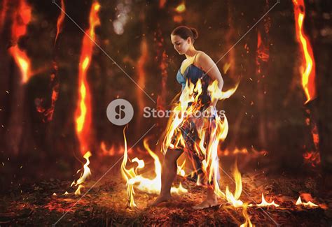 A Woman Walks Through A Burning Forest Fire Royalty Free Stock Image