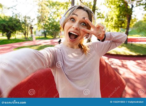 Beautiful Cheerful Young Fitness Sports Woman Posing Outdoors In Park