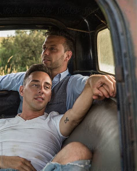 Gay Men Cuddling Romantically In Vehicle By Stocksy Contributor My