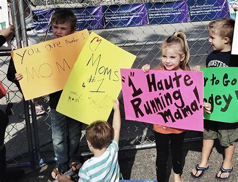 Running Signs Displayed By Kids At A Marathon