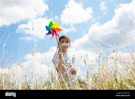 Girl With A Pinwheel On A Meadow Stock Photo Alamy
