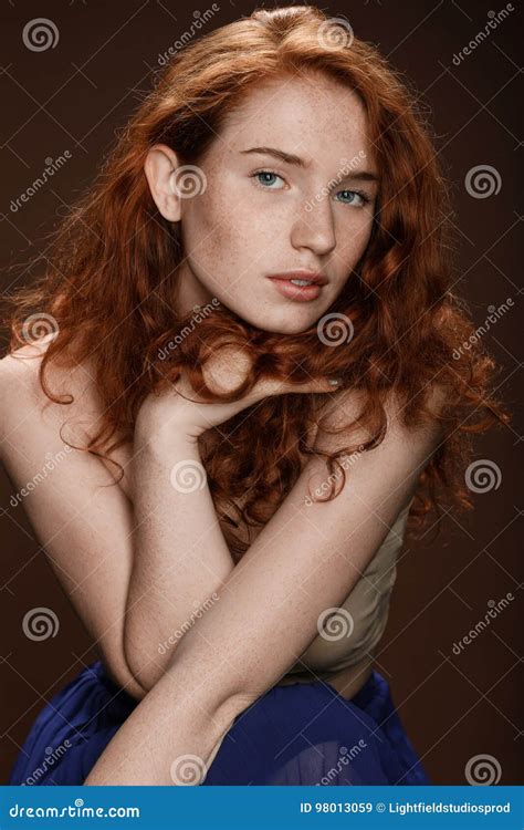 Portrait Of Attractive Tender Redhead Woman Posing For Studio Shot