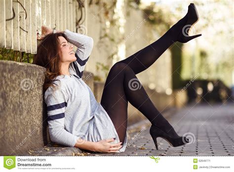 Funny Female Model Of Fashion With High Heels Sitting On The Flo Stock