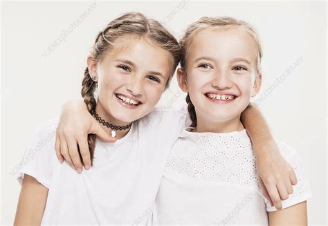 Two Girls With Arms Around Each Other Head And Shoulders Stock Image