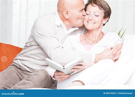 Affectionate Man Kissing His Wife On The Cheek Stock Image Image Of