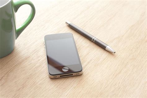 Free Image Of Modern Mobile Phone Lying On An Office Desk