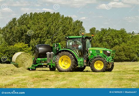 Modern John Deere Green Tractor With Round Bale Wrapper Editorial Image