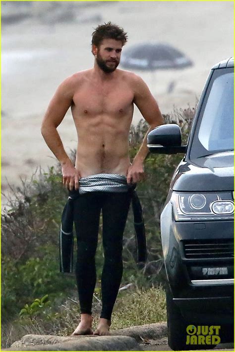 Liam Hemsworth Bares Ripped Abs While Stripping Out Of Wetsuit Photo Liam Hemsworth