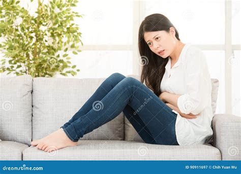 Beautiful Young Woman Sitting And Suffering From Abdominal Pain Stock 388