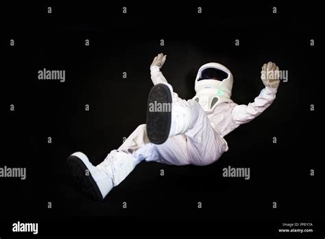 Falling Astronaut In Space In Zero Gravity On Black Background Stock