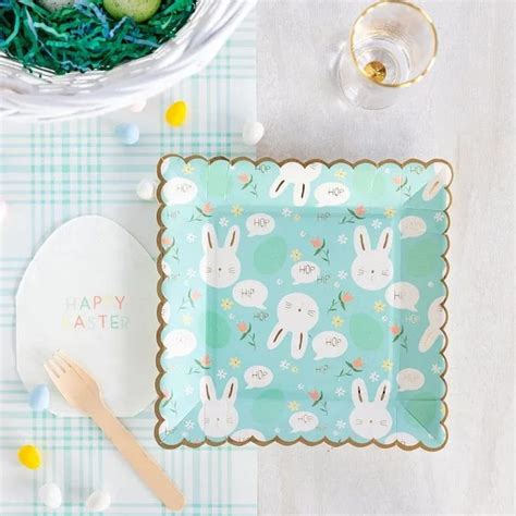 An Easter Themed Table Setting With Bunny Plates And Napkins
