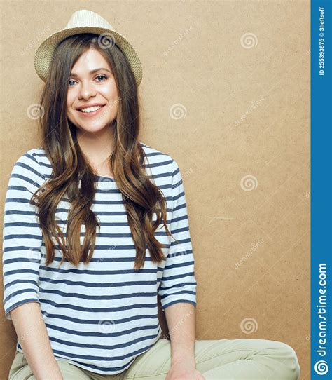 Woman Sitting In Front Of Wooden Wall Stock Photo Image Of Casual