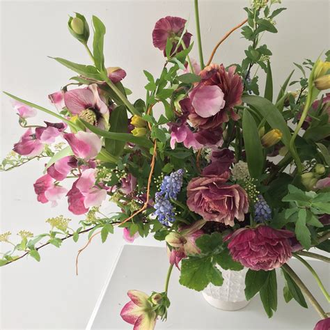 create a ranunculus flower arrangement with moody tones