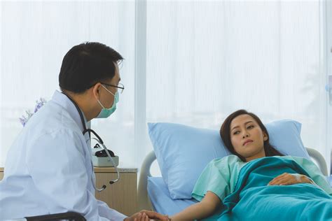 male asian doctor offers chronic illness management counseling for a female adult patient in