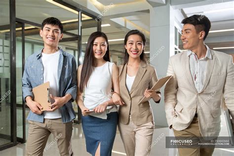 Happy Young Professional Asian Business People Holding Clipboards And