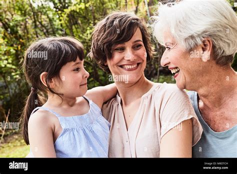 Portrait Of Senior Woman With Grown Daughter And Granddaughter