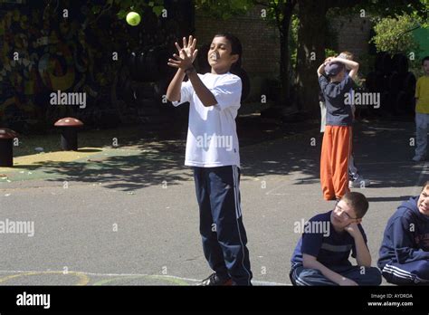 Young Boy Catching A Ball In Primary School Playground Stock Photo Alamy