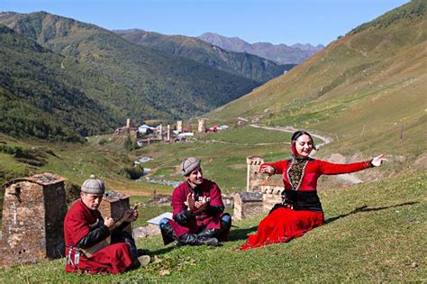 Georgian Men And A Girl Sing In Local Dresses And Dance In The
