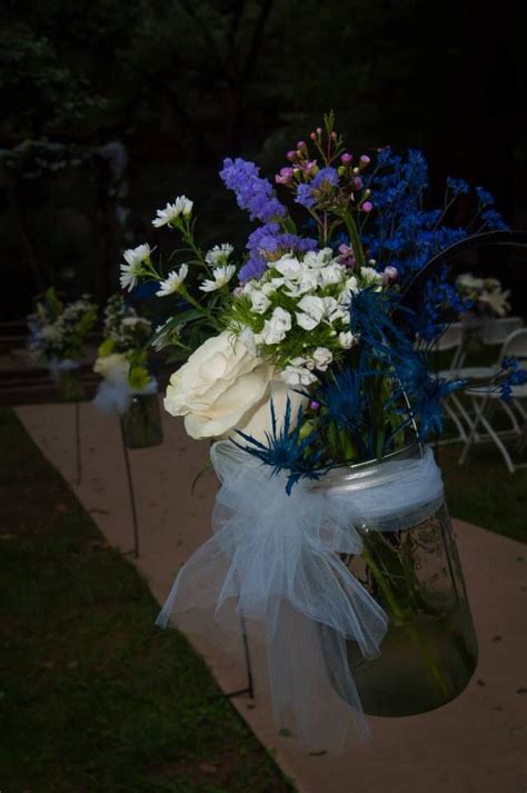 Beautiful Flowers In Mason Jars On Shepherds Hooks Island Weddings