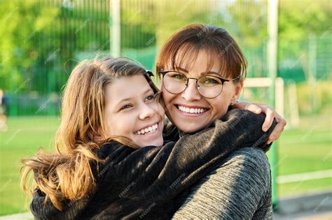 Premium Photo Portrait Of Happy Mom And Preteen Daughter Hugging Together Outdoor