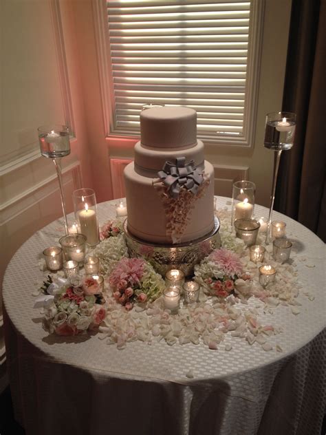 A Lovely Table For The Cake With Candles And Flowers Wedding Cake